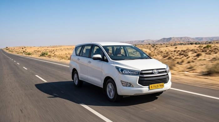 White Toyota Innova Crysta driving on a Rajasthan highway