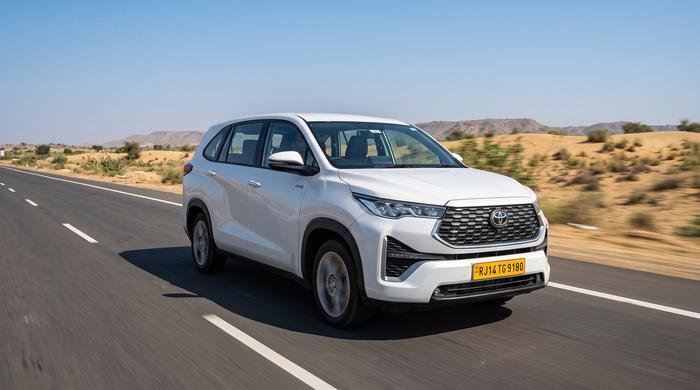 White Toyota Innova HyCross driving on a Rajasthan highway